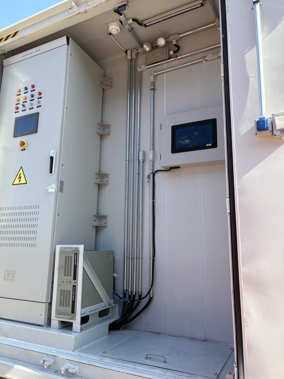 Control cabinet with operator panel inside an E-HUB energy storage container